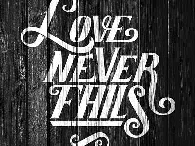 Love Never Fails flourishing lettering love panel quote script typography white wood