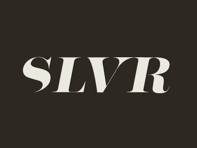 Silver masthead cream lettering logo publication serif