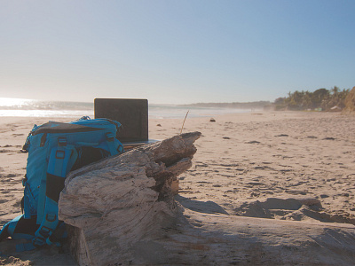 An office with a view backpack beach desk laptop workspace