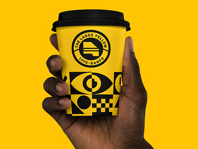 Hand Holding Coffee Cup Mockup - The Lagos Yellow badge branding design lagos logo logomark mockup monogram typography