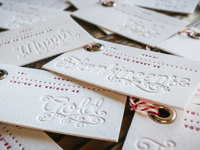 Letterpress Holiday Tags blind emboss christmas emboss grommet holiday lettering letterpress red script typography white