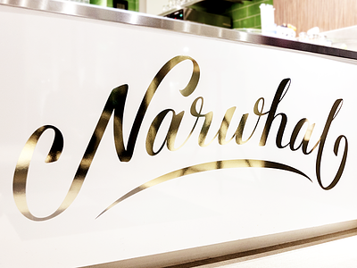 Cafe Narwhal gold foil lettering signage