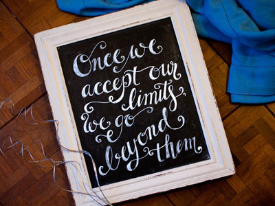 "Once we accept our limits..." chalkboard typography quotes