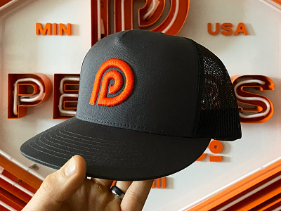 Peters Design Company Hat and Branding american badges brand branding classic crest custom design font hat logo logos minneapolis neon orange p pattern sign signage typography