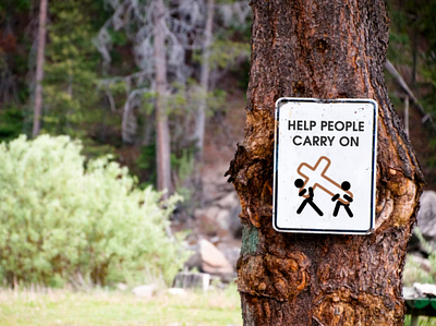 Help people carry on. bible christian cross jesus stick figure stick figures street sign tree trees woods