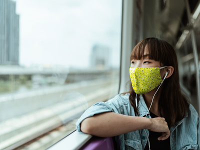Mask Mockup With Young Woman in Train [Free PSD Mockup] anti pollution apparel cloth mask dust protection face mask facemask free download free mockup free psd freebie mask medical mask mockup psd mockup woman