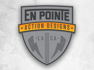 En Pointe Action Designs Logo block bold bolt condensed gradient gray orange shield star