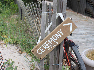 Ceremony beach directional handlettering painting reclaimed signage sustainable wedding wood