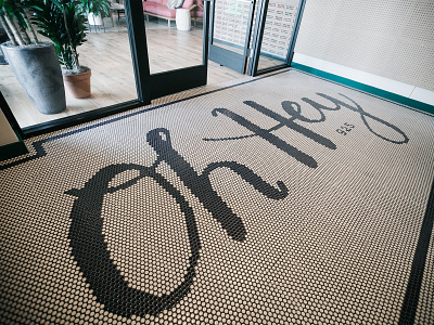 Oh Hey black and white cursive floor handdrawn handlettering hey installation lettering script tile type typography welcome wework