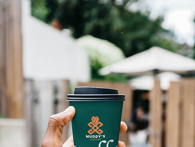 Cup Mockup with Hand for muddy's coffee logo design branding design icon illustration logo