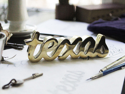 Texas Script in casted brass brass hand lettering physical product script sculpture texas