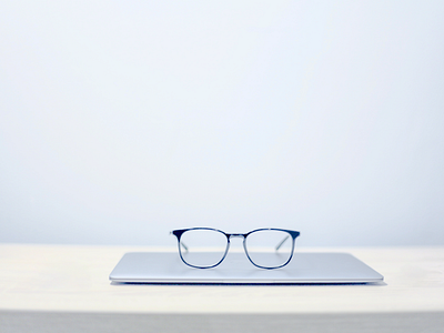 Glasses Sitting on Laptop White