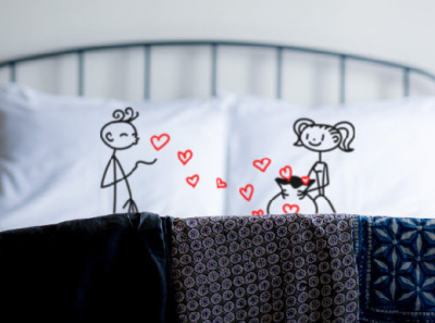 A stickman boy on one pillow sending kisses A stick