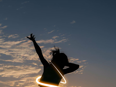 girl jumping back light sunset