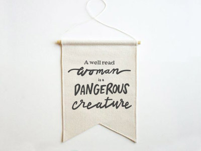 A well read woman is a dangerous creature ai banner mockup hand written quote script