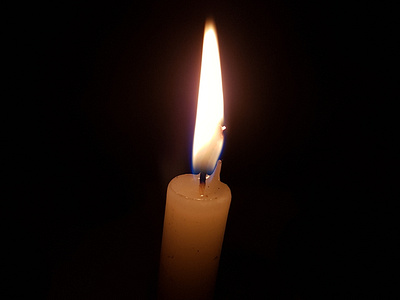 Candle burning in the dark