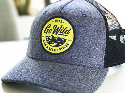 Go Wild Hat badge branding cap hat illustration lettering mountains patch river script