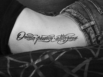 Omnia calligraphy tattoo