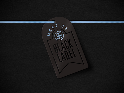 Next 38 Black Label metal packaging tag