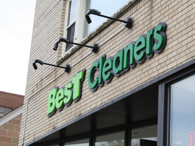 Best Cleaners branding business name green logo outdoors sign