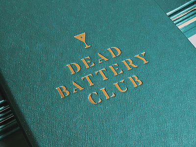 Dead Battery Club Embossed Menu Cover bar branding gold icon identity logo mark menu restaurant type typography