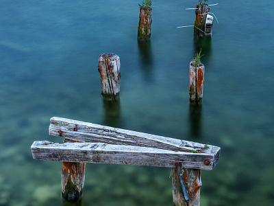 Broken-down Pier In Shallow Water