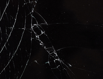 Cracked glass against a black background