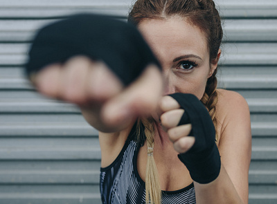 Sportswoman looking at camera and punching branding design icon photo