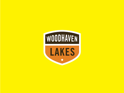 Woodhaven Lakes Badge acorn badge brown cabin campaign campfire campground camping crest orange star thick yellow