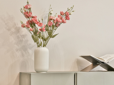 Flower in vase and a book on the table plant