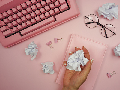 A woman's hand crumples a piece of paper design