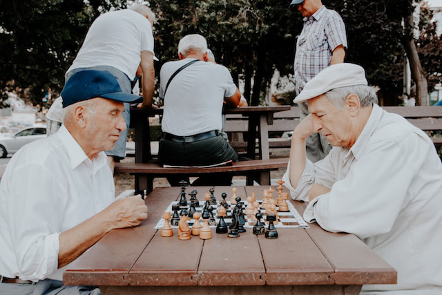 Two elderly men engrossed in a chess game