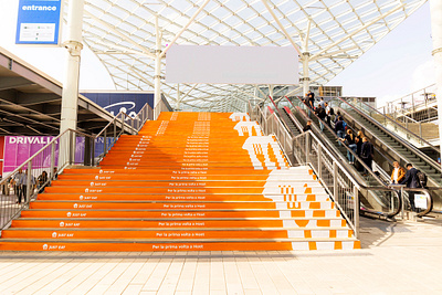 Just Eat at HostMilano: Scaling New Heights ad advertising brand design branding concept dtp graphic design logo ooh orange outdoor print stairs steps stripes wrapping