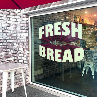 Hand painted window for Lodge Bread - Woodland Hills branding design environmental design hand painted illustration logo sign graphics sign painter sign painting