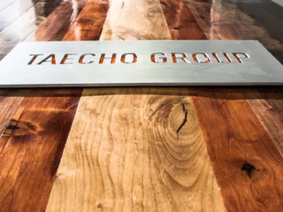 Taecho Group Sign cutout metal sign table wood
