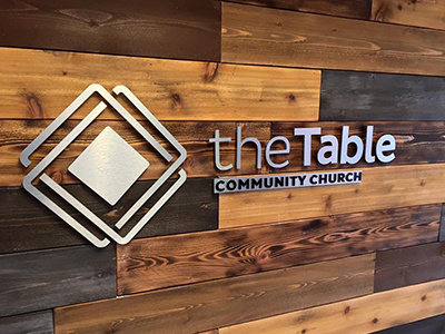 The Table Logo Wall branding church logo signage table wood