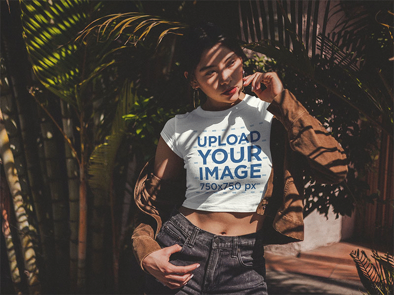 Beautiful Girl Wearing A Crop Top T Shirt Mockup Under Palms apparel mockup crop top crop top mockup t shirt t shirt design t shirt mockup