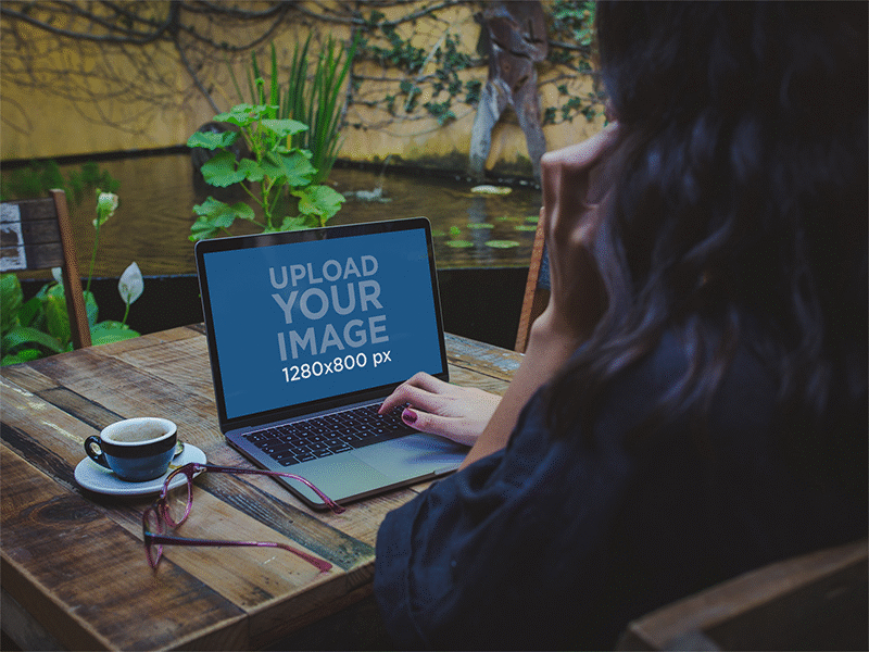 Woman Talking On The Phone Using A Macbook Pro Mockup Near A Fou digital mockup macbook macbook air macbook pro macbook pro retina mockup mockup generator ui ux