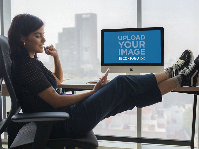 Girl Checking Her Phone At The Office Near An Imac apple imac digital marketing imac imac pro ios mockup mockup generator ui ux web design