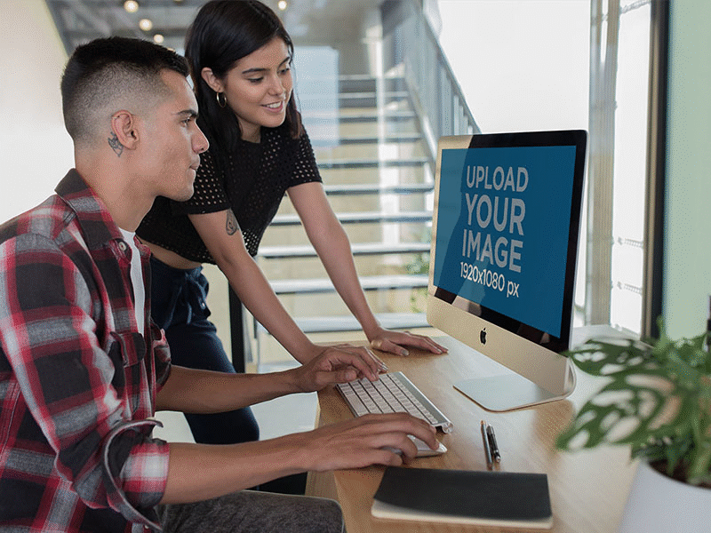 Girl With A Man Working At A Modern Office With An Imac Mockup apple imac digital marketing imac imac pro ios mockup mockup generator ui ux web design