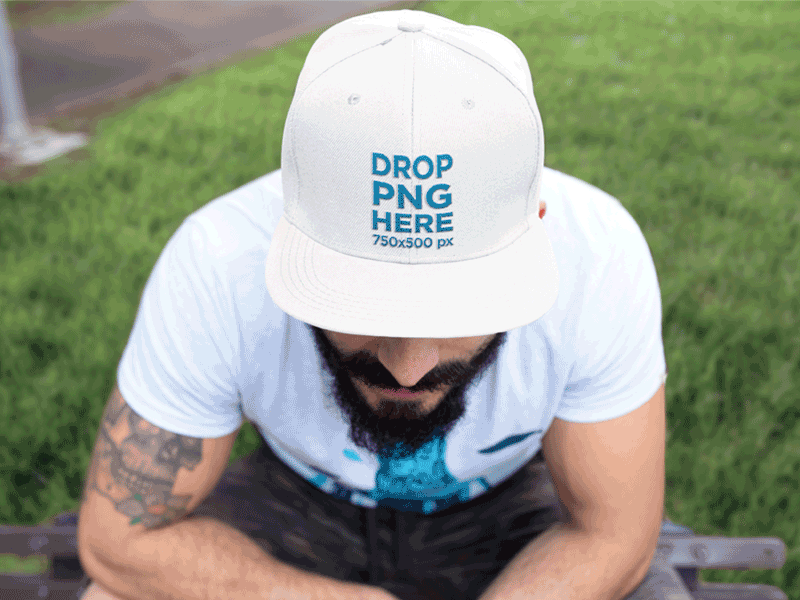 Embroidered Hat Mockup of a Guy Sitting in a Park design template hat logo maker mockup sports