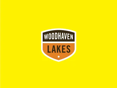 Woodhaven Lakes Badge acorn badge brown cabin campaign campfire campground camping crest orange star thick yellow