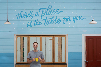 ‘A Place at the Table’ Complete Mural community hand lettering lettering mural mural painting muralist paint pattern script lettering type typography welcome