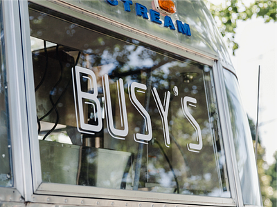 Busy's airstream branding logo signage typography vinyl signage