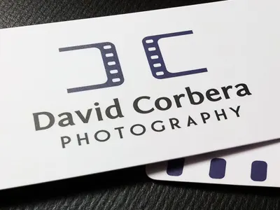 David Corbera Photography Business Card ali ambigram business card c card corbera d david david corbera dc effendy film strip logo logos mark matte monogram photography print reel rounded royal purple stationery visiting card visitng card