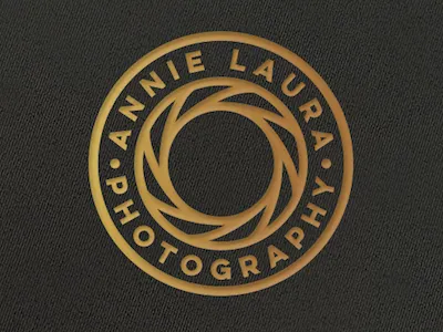 Annie Laura Photography badge black circle gold lens logo minimal photography