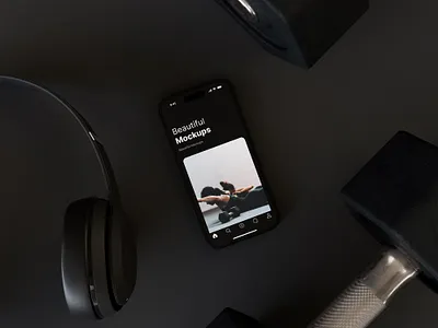 Free iPhone 14 Pro Mockup On Floor In Fitness Studio (Black) dumbbell dumbell fitness headphones iphone mockup photoshop pro psd studio training workout