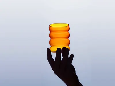 Amber Balance – Glass Art Capture amber tones artistic product color harmony creative composition design direction design still elegant lighting glass design handcrafted object high contrast light balance modern minimalism moody lighting product photography shape repetition silhouette hand studio photography visual rhythm