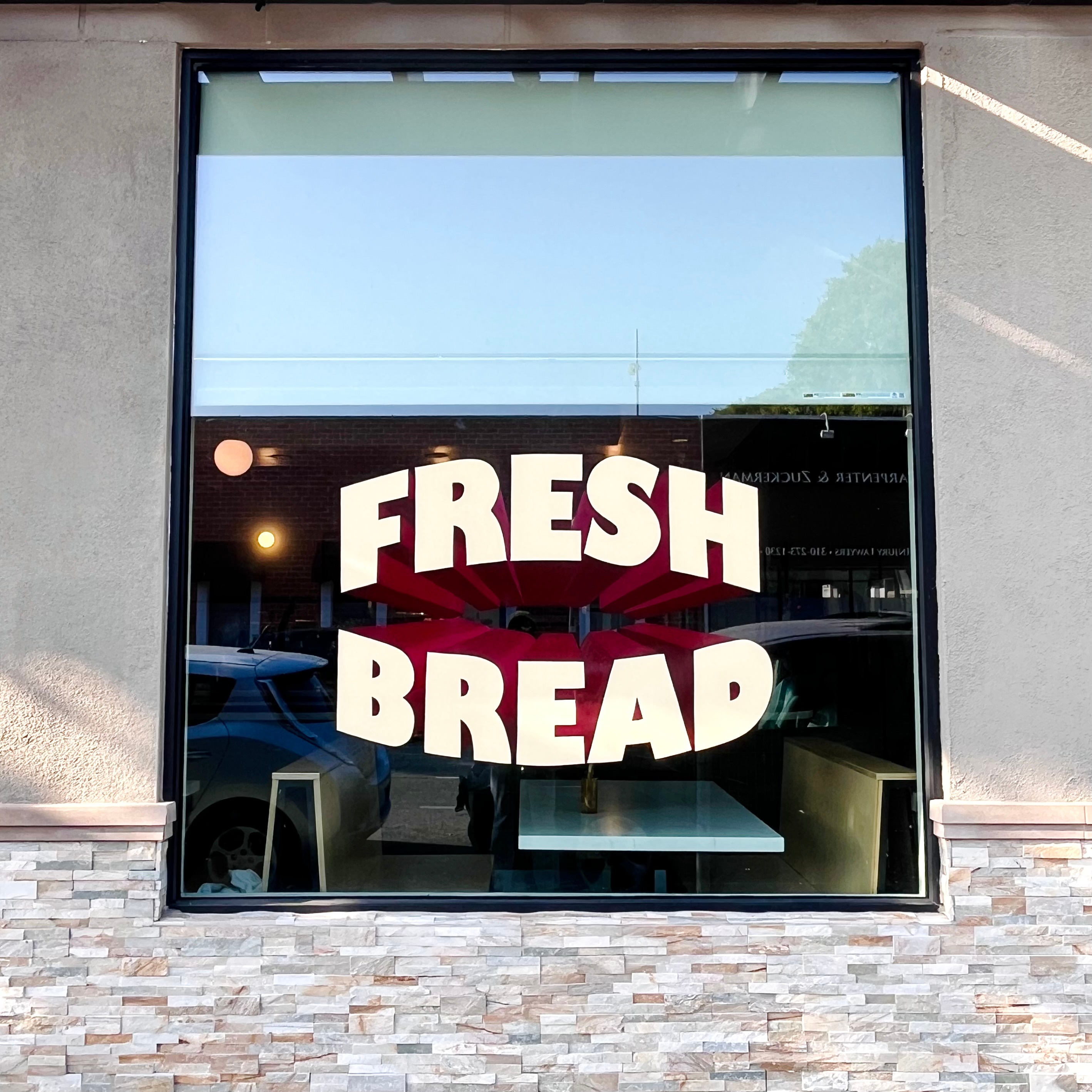 Hand painted windows for Lodge Bread - Beverly Hills beverly hills branding design environmental design hand painted logo sign graphics sign painter sign painting ui