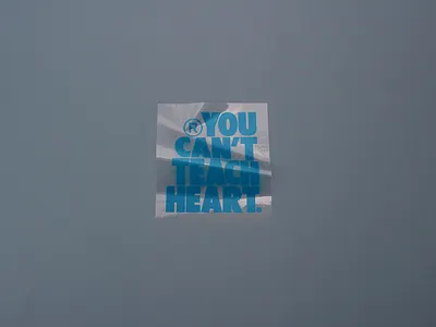 Custom Transparent Sticker with Bold Blue Text on Flat Surface